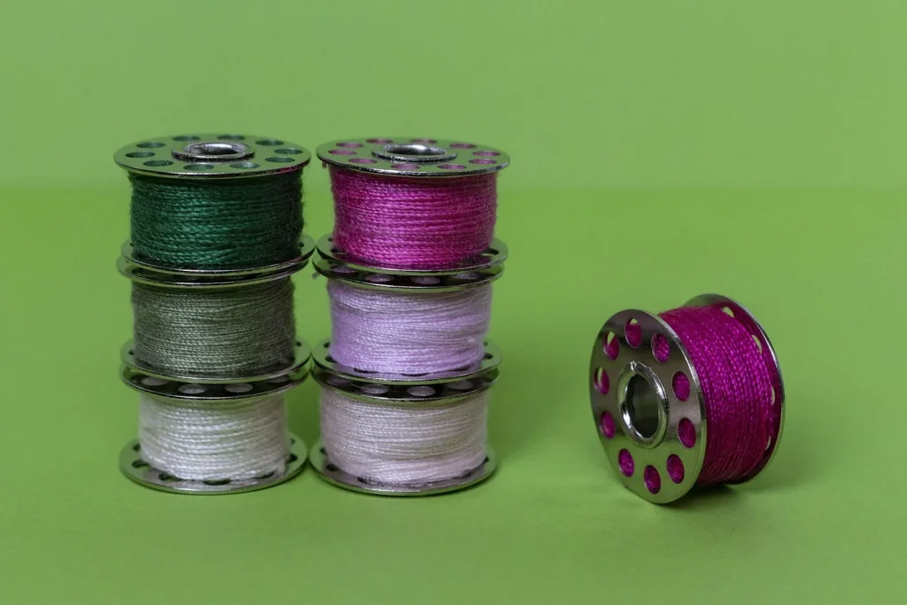 A snarl of loose thread built up around the bobbin area beneath the needle plate