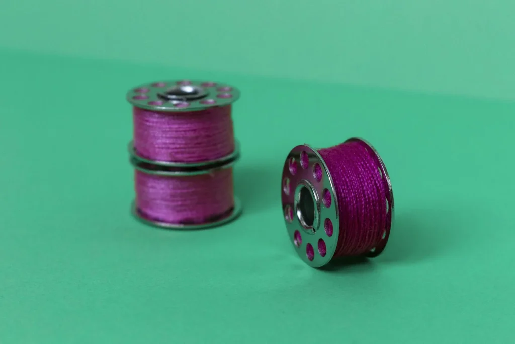 Thread seated correctly inside a Brother sewing machine tension disc assembly