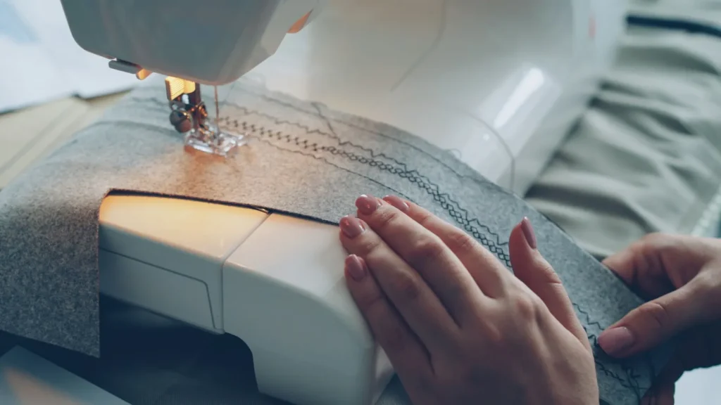 Checking the underside of a test seam on scrap fabric for even stitch tension