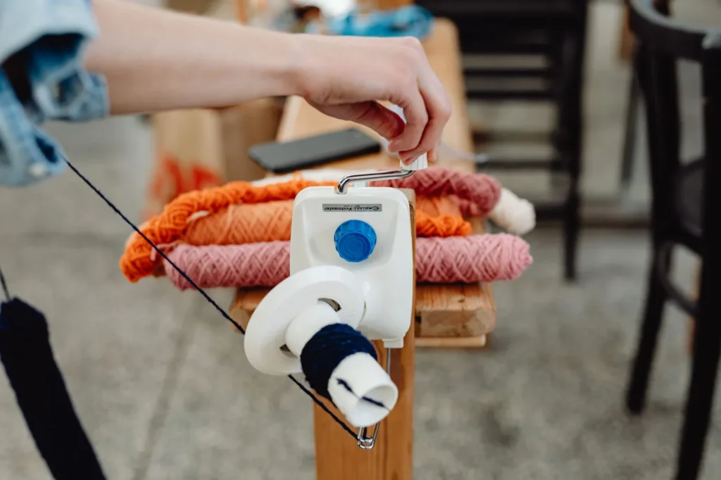 A bobbin winding on a Janome sewing machine with the rubber friction tire visible