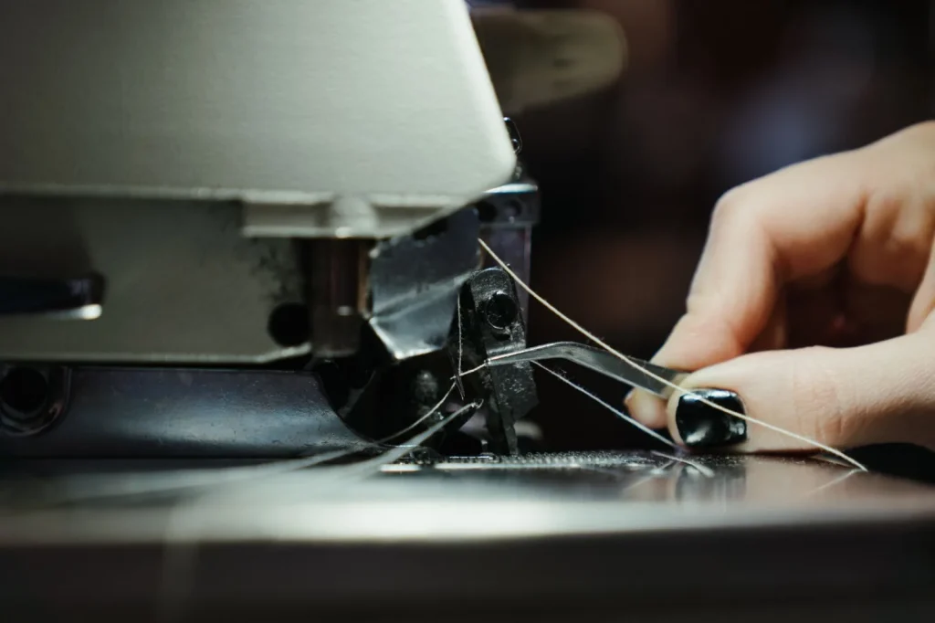 Guiding thread through the take up lever on a newly unboxed sewing machine
