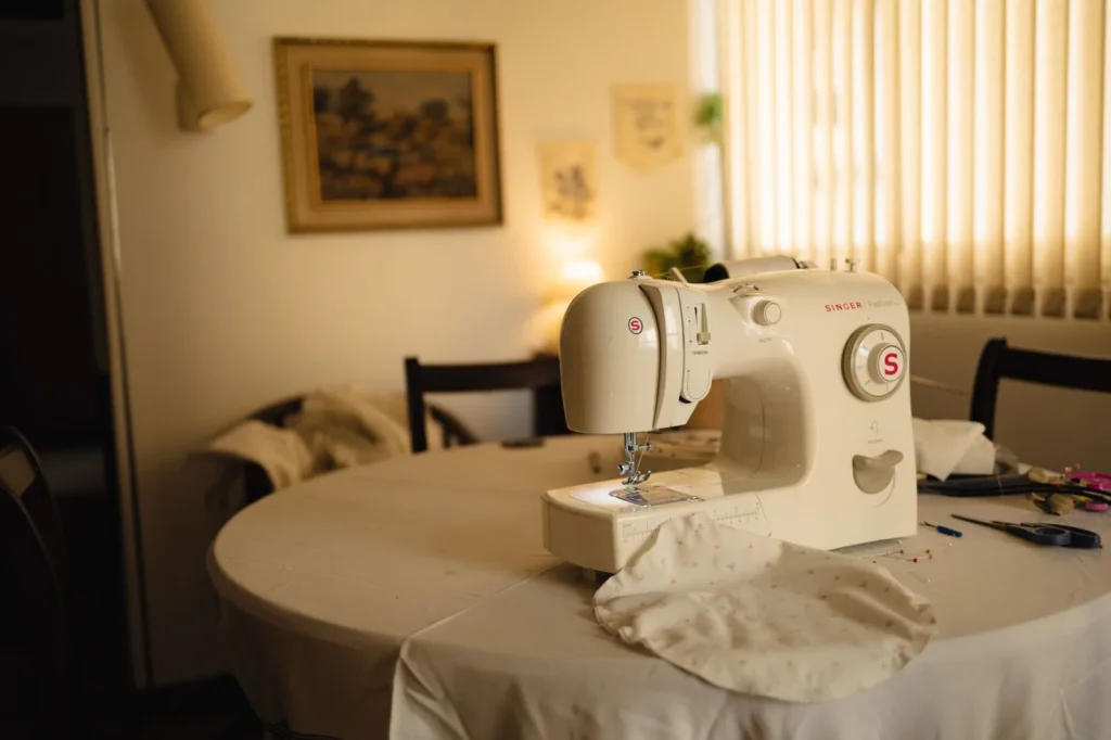 A Singer Featherweight 221 sewing machine sitting open in its original carrying case