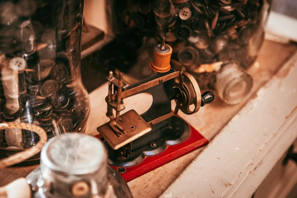 Vintage straight stitch machine with a darning plate covering the feed dogs