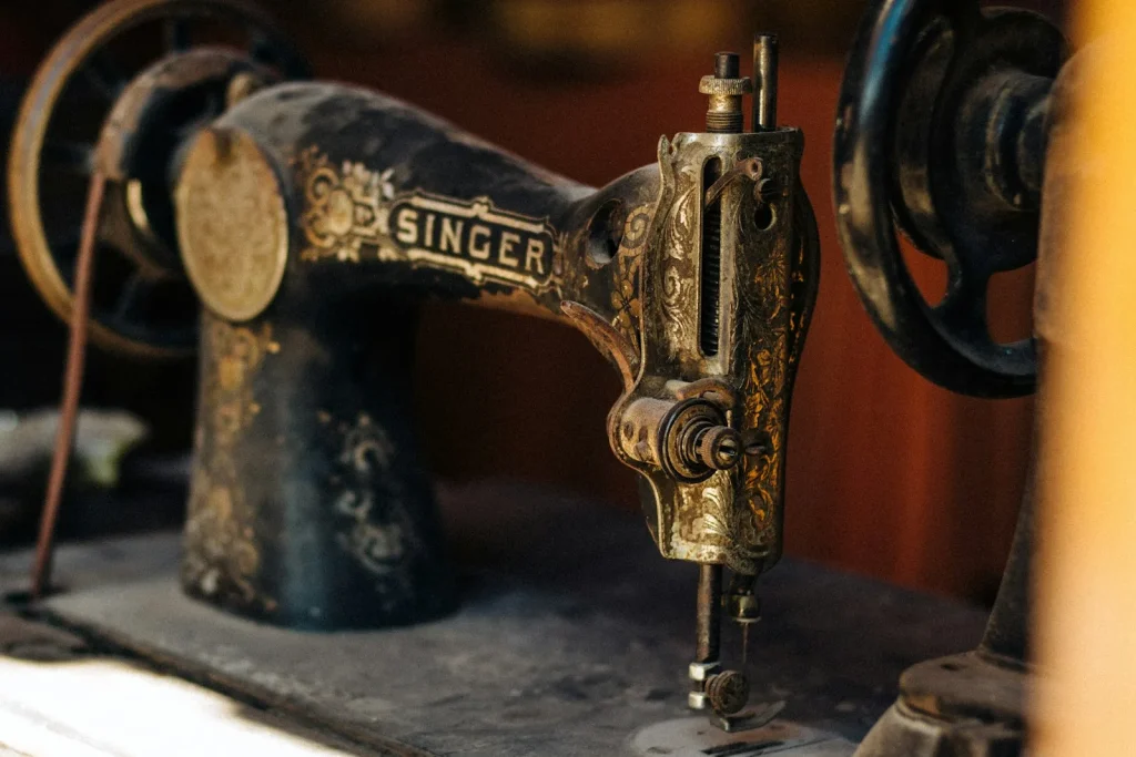 Close up of hands turning a vintage handwheel with the inner clutch knob visible