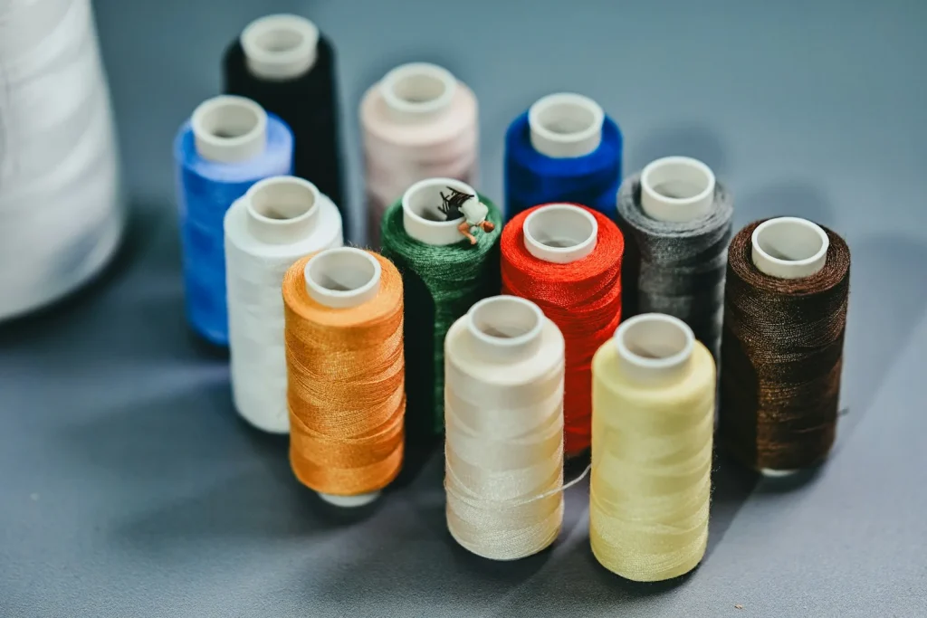 Brushing lint and loose thread out of the bobbin area with the needle plate removed