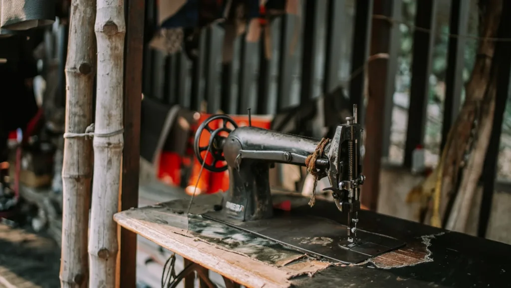 A handwritten itemized repair estimate resting on a workbench beside an open machine