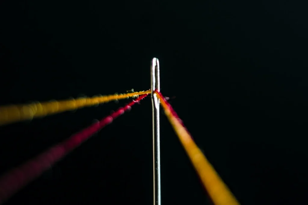 Installing a fresh needle with the flat side of the shank facing the back