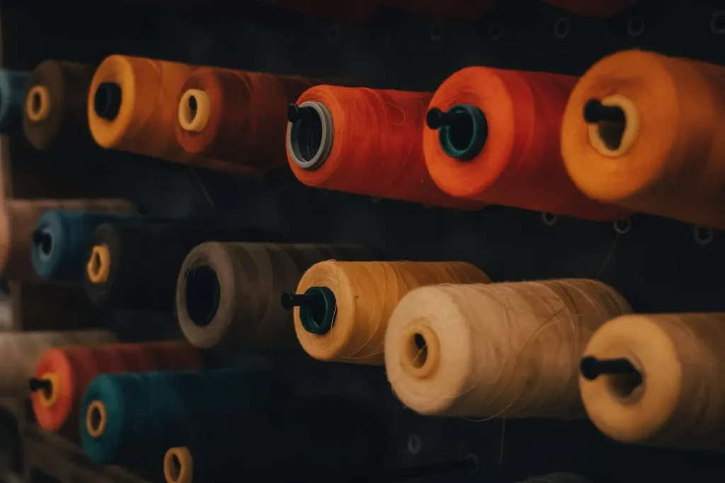 Two contrasting spools of thread loaded on a sewing machine for a tension test