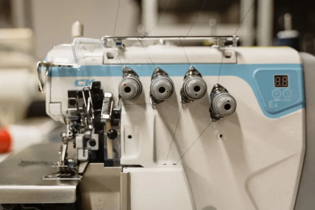 A sewing machine takeup lever with thread correctly seated in its hook