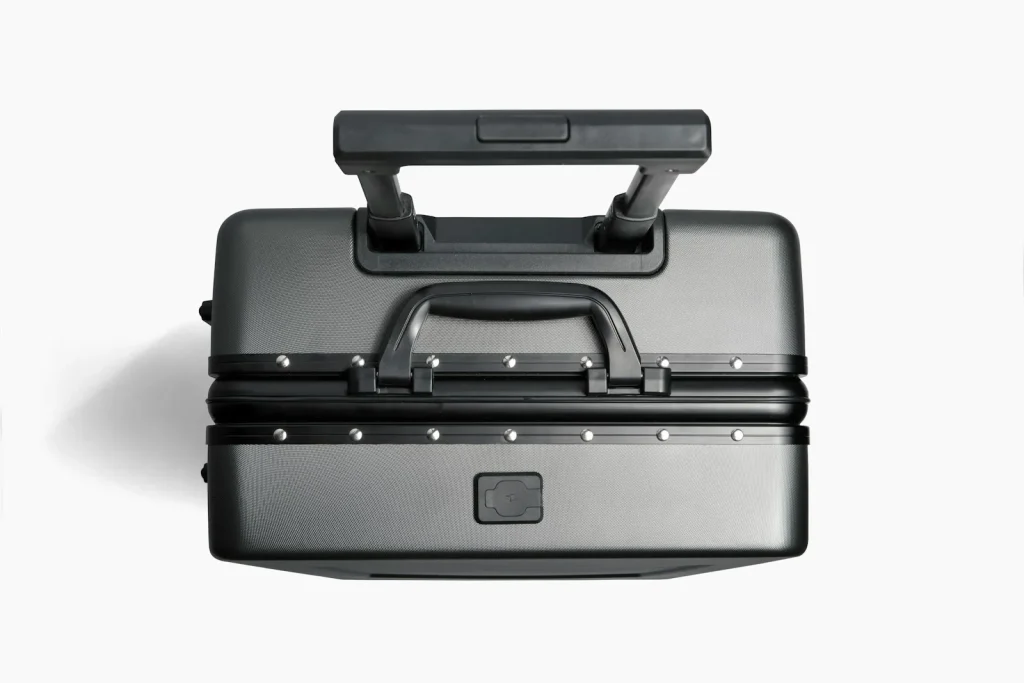 A padded rolling trolley bag holding a sewing machine upright in a car footwell